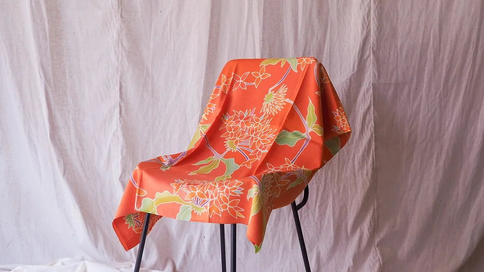 Handwoven silk, painted batik, shades of orange, sold by the yard, code A11-CT-102049.