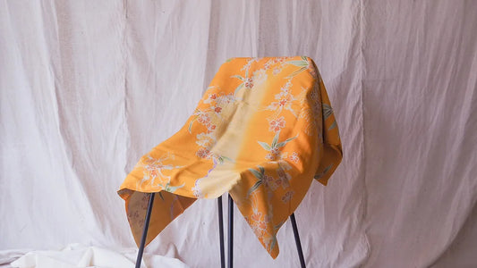 Handwoven silk, painted batik, shades of orange-yellow. Sold by the yard, code A11-CT-102053